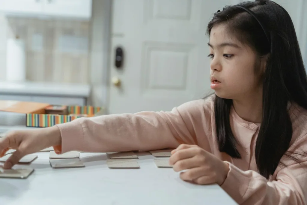 Child with Down syndrome playing a memory card game