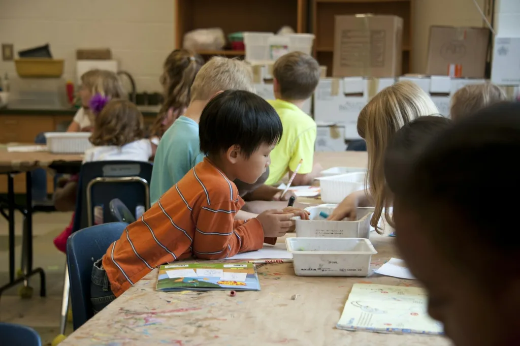 Students working together during a special education classroom activity, average salary of special education teacher